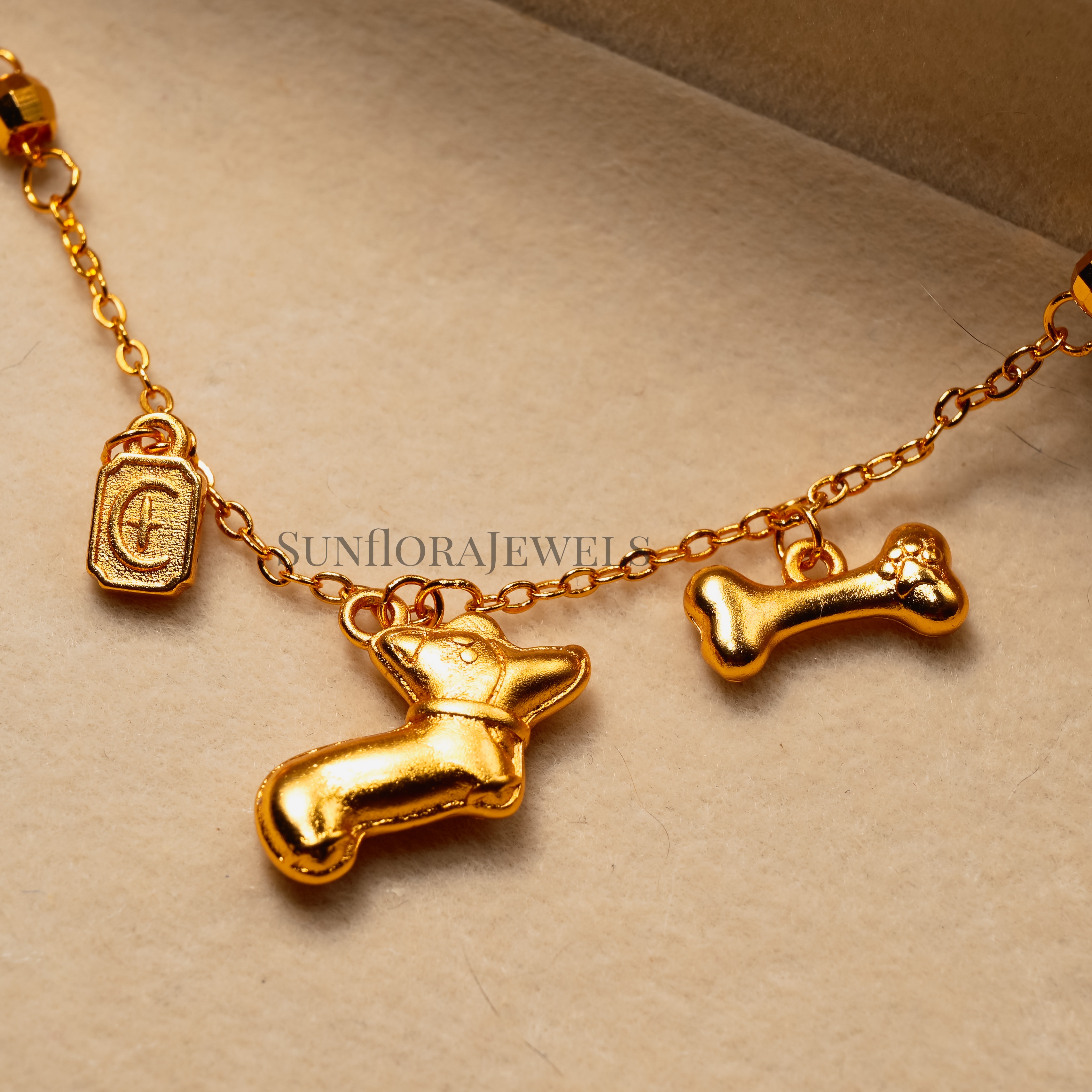 Gold Bracelet Featuring Dog and Bone Charms